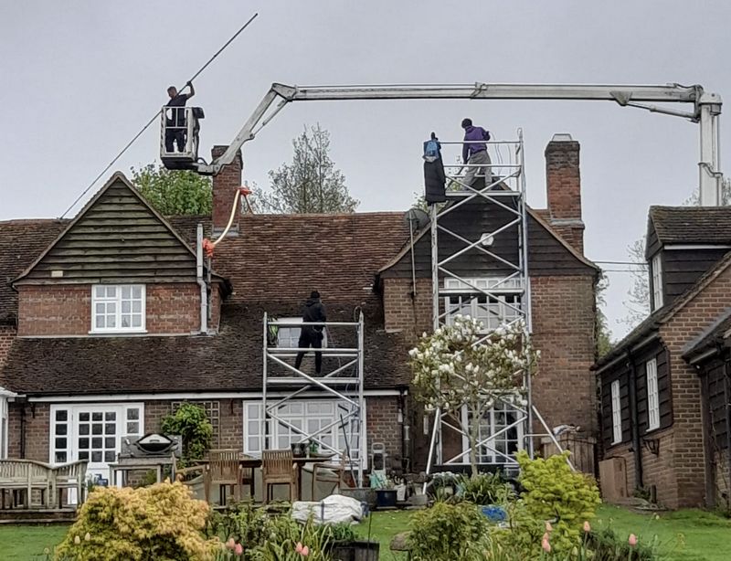 The Moss Cleaners using cherry picker and scaffolding to clean roof safely and professionally in Hurstpierpoint, West Sussex